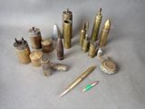 many different types of bullet shells and pens on the table