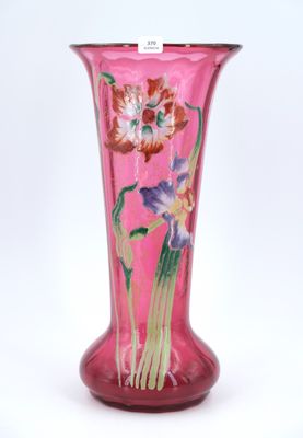 purple glass vase with flowers on it on a white background