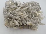 a pile of silver and white lights on a white surface
