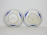 pair of blue and white plates on a white surface
