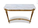 a white marble topped console table with gold leaf legs