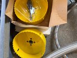 a box with two yellow cups and a hose in it