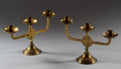 pair of antique brass candlesticks on a stand