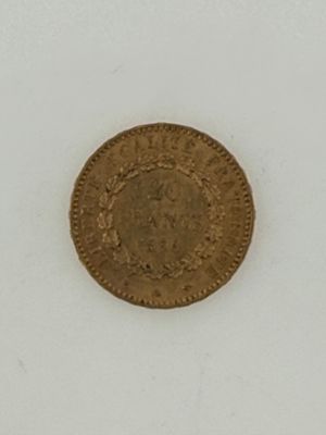 an old gold coin on a white surface with a white background