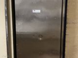 a stainless steel refrigerator in the corner of a room