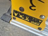 a close up of a yellow sign on a metal pole