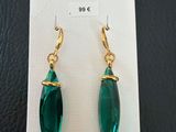 a pair of green earrings on a white card