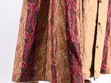 a woman ' s skirt with a red and brown pattern on it
