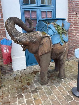 a statue of an elephant with a bag on it ' s back