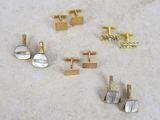 four pairs of gold and silver cufflinks with mother of pearl in them