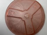 a pink plastic plate with a star wars design on it