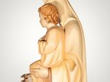 a statue of a woman holding a child wearing a crown