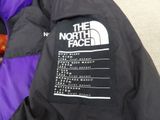 the north face purple and black down filled jacket with the north face logo on it