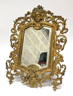 an image of a gold mirror with a face on it
