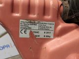 a label on the side of a pink gas can