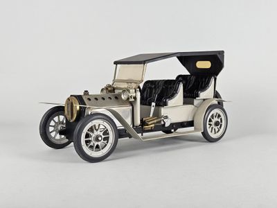 une maquette d'une vieille voiture posée sur une surface blanche