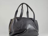 a black leather handbag on a white background