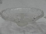 a glass bowl with a cross on it sitting on a table