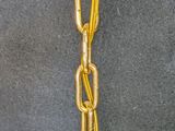a gold chain hanging from the ceiling of a room