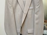 a suit hanging on a hanger in a room