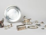 several silver objects are arranged on a white surface