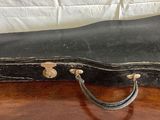 a guitar case sitting on top of a wooden table