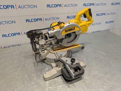 a close up of a circular saw on a table in front of a wall