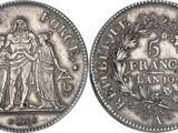 a silver coin with an image of a woman and a man on it