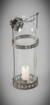 a glass candle holder with a candle inside of it