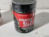 a container of creatine zero next to a bottle of creatine zero