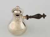 an antique silver coffee pot with a wooden handle