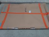 a large cardboard box sitting on the ground in front of a garage door
