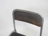 a metal chair with a leather seat and back rest