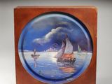 a plate with a painting of a sailboat on the water