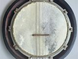 a close up of a banjo hanging on a wall
