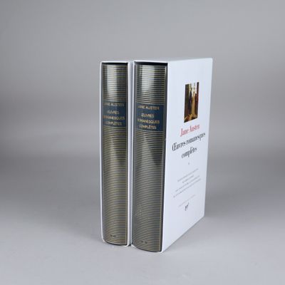 two books in a white box on a gray surface