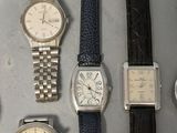 several different types of watches are lined up on a table