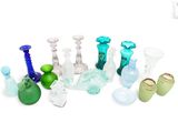 many different colored glass vases sitting on a white surface