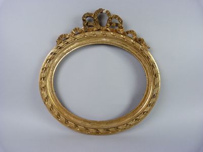 an ornate gold frame with a crown on top of it