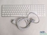 a computer keyboard and a charger sitting on a table