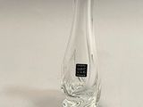 a clear glass vase with a black label on it