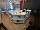 a desk with a laptop on it in the middle of a room