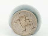 a close up of a vase with a stamp on it