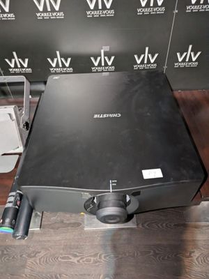 a laptop computer sitting on a table in front of a wall