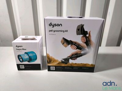 two boxes of the dysonon pet grooming kit are sitting on a table