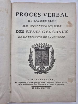 un livre ouvert sur lequel figure un blason