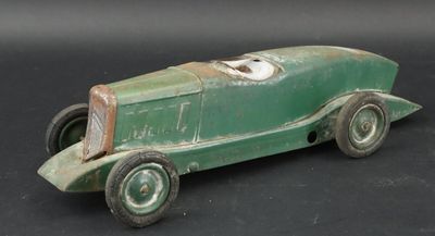 a green toy car that is sitting on a black surface
