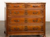 an antique wooden chest of drawers with marble top