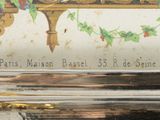a close up of a silver plate with a painting on it