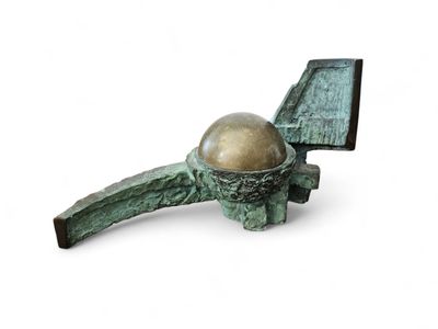 a sculpture of a bird nest with a golden egg in it